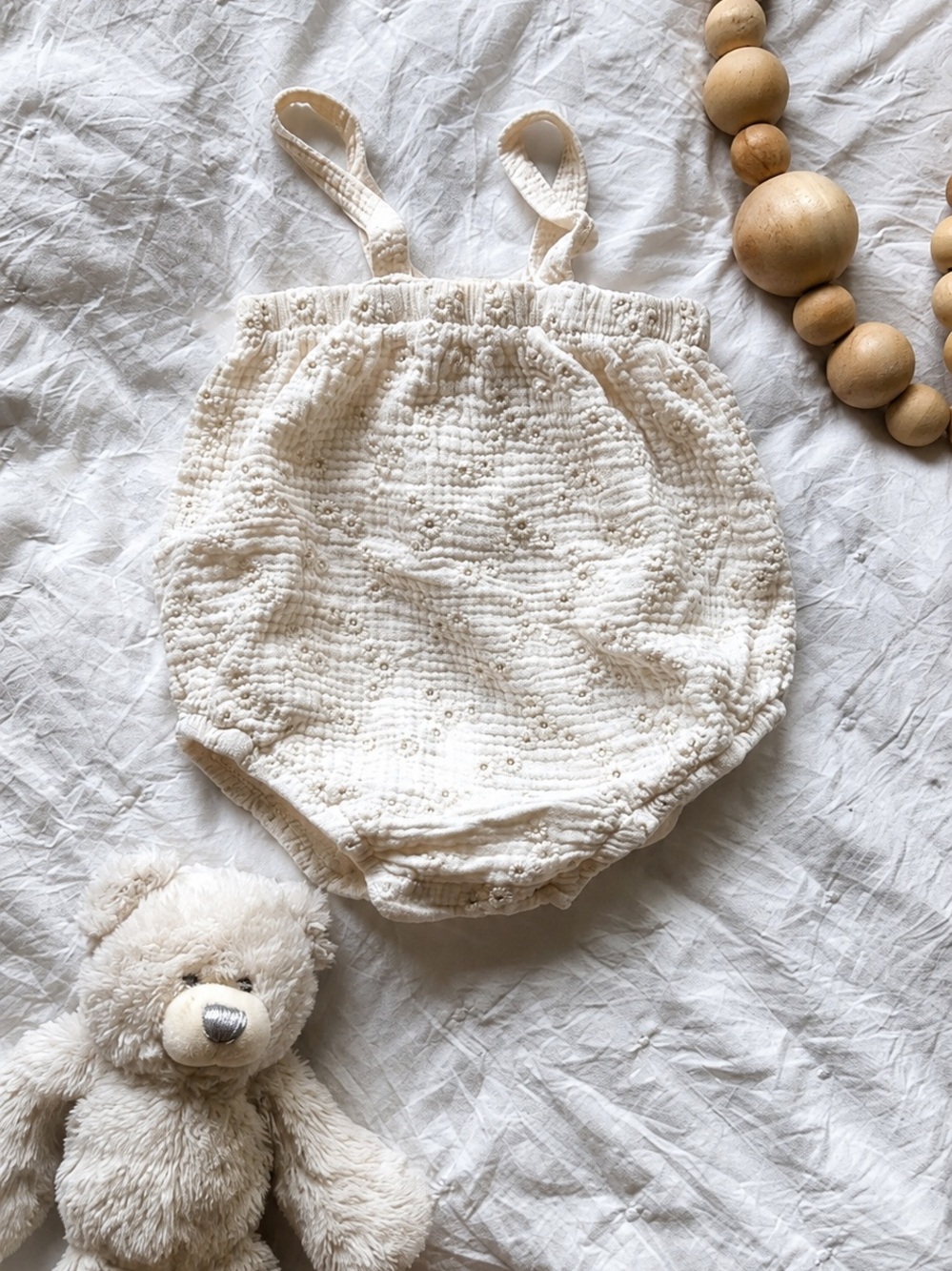 neutral cream baby bubble romper with adjustable straps